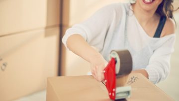 woman fixing moving boxes
