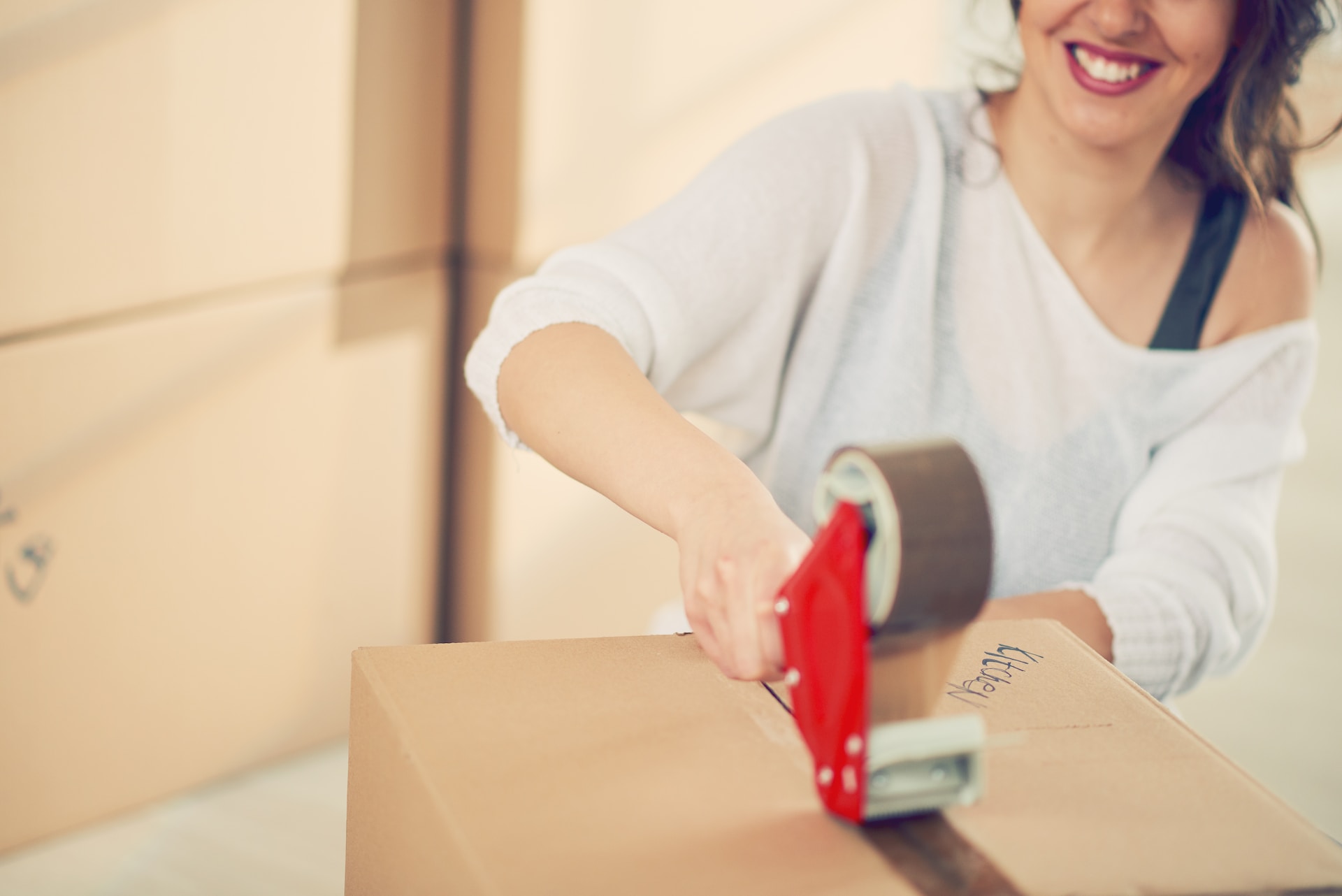 woman fixing moving boxes