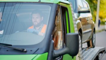A grab lorry hire transporting a car